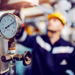 Pressure gauge with a man in the background